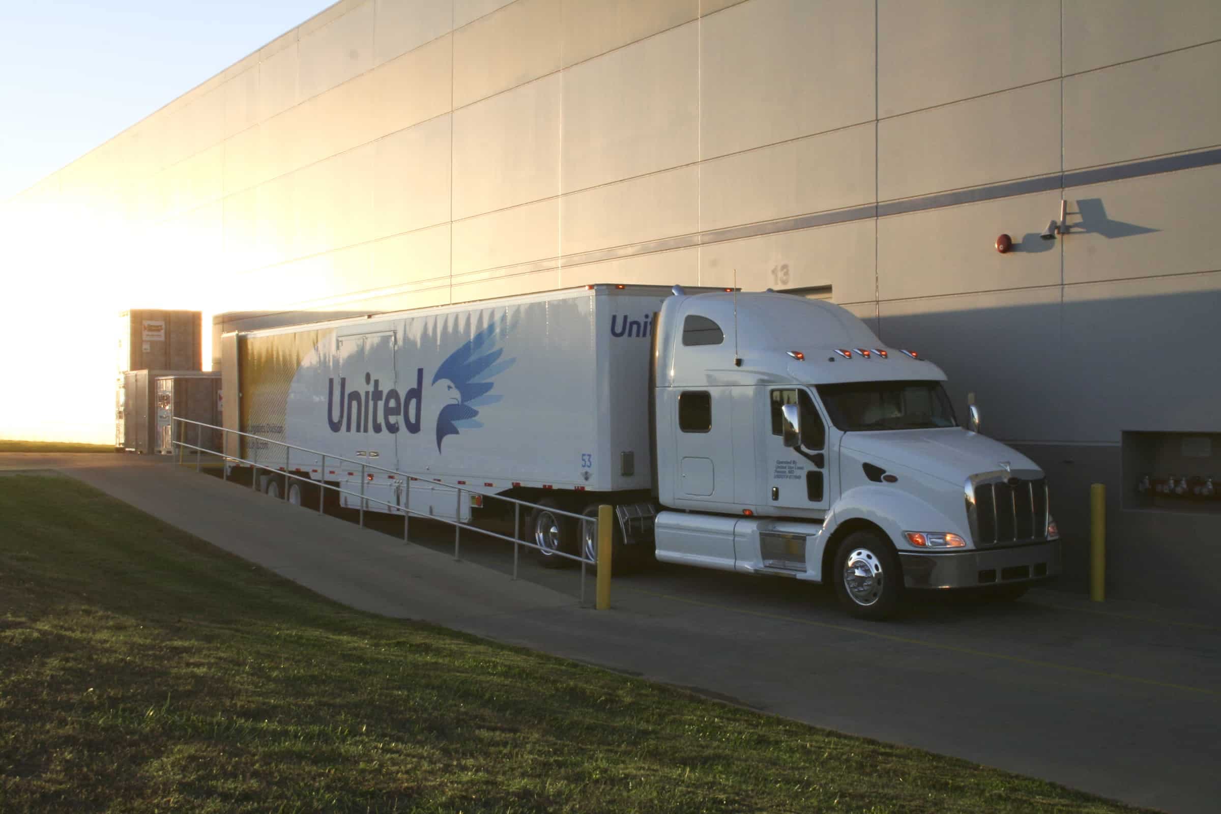 United Van Lines truck at a warehouse at sunset